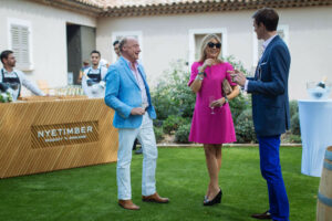 three people having a discussion at an a outdoor event