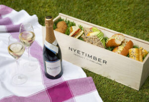 picnic box including food, wine bottle and two wine glasses