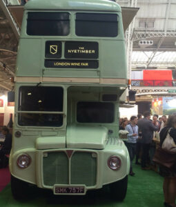 front of green bus at a wine event
