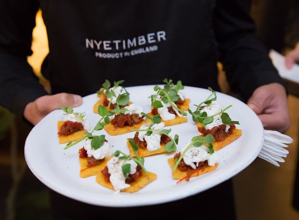 a man holding a plate of canapes