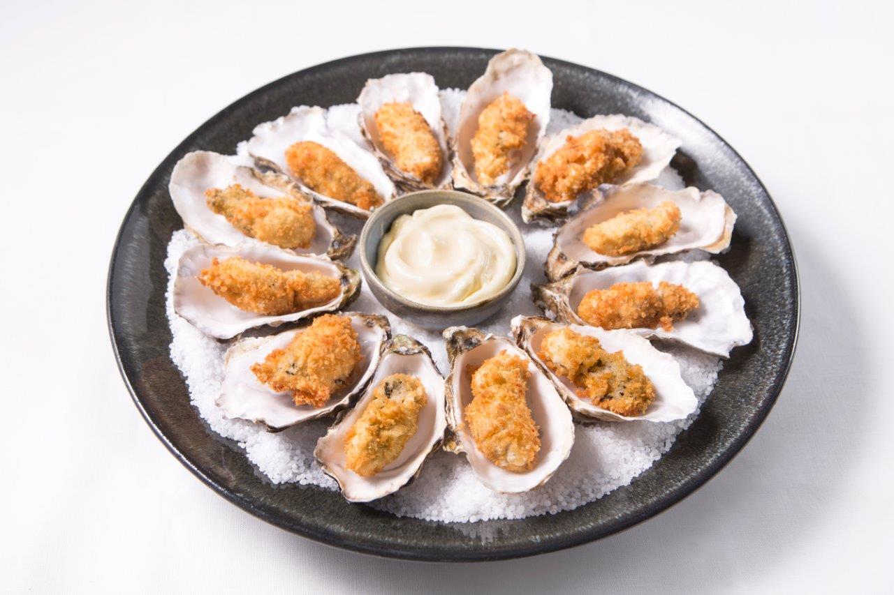 oysters placed in a circle around the plate, mayonnaise in the centre