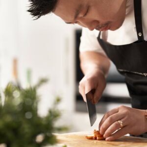 a chef chopping food on a cutting board