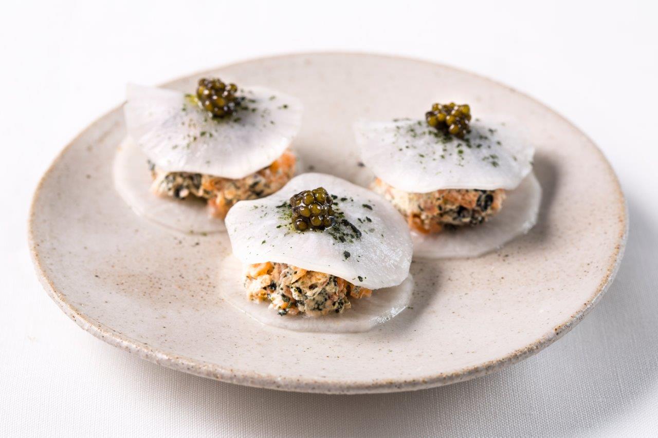 three smoked salmon canapes on a plate