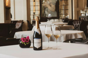wine bottle and glasses on empty table in restaurant
